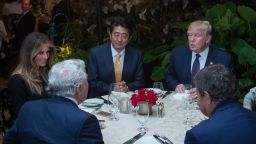 US President Donald Trump (facing right), Japanese Prime Minister Shinzo Abe (facing center), US First Lady Melania Trump (L), and Robert Kraft (2nd-L), owner of the New England Patriots, sit down for dinner sat Trump's Mar-a-Lago resort on February 10, 2017 in West Palm Beach, Florida.  / AFP / NICHOLAS KAMM        (Photo credit should read NICHOLAS KAMM/AFP/Getty Images)