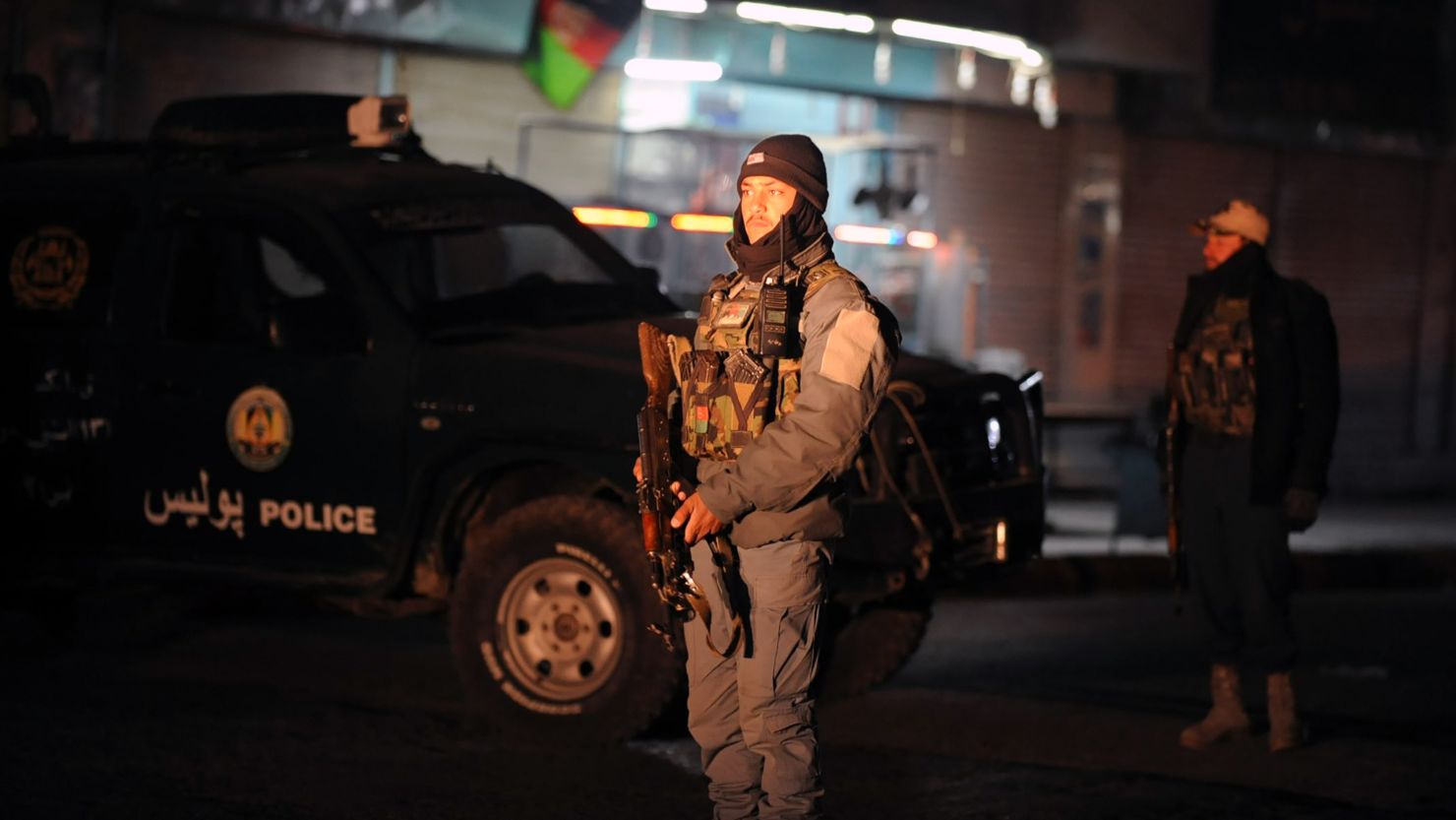 An Afghan police officer stands guard at the Kandahar governor's compound after the January 10 blast. 