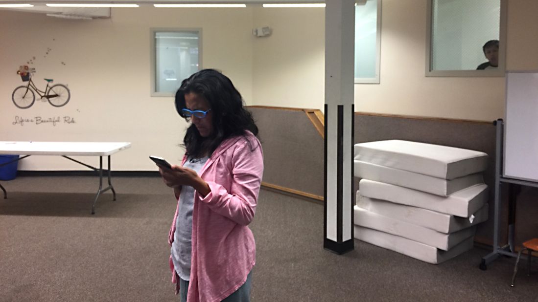 Vizguerra waits at a church to hear the resolution of her request for a stay of deportation as her son, Roberto, looks on.