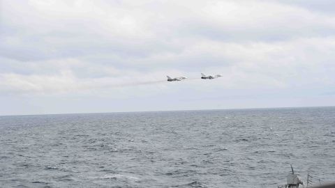 A pair of Russian Su-24s pass within close proximity of the guided-missile destroyer USS Porter while the ship conducts routine maritime operations in international waters.