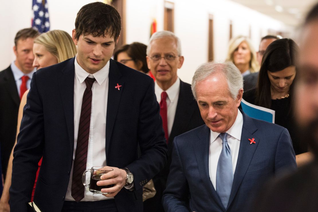 Ashton Kutcher walks with Senate Foreign Relations Committee Chairman Sen. Bob Corker (R-TN) before testifying on Capitol Hill on February 15, 2017 in Washington, DC. 