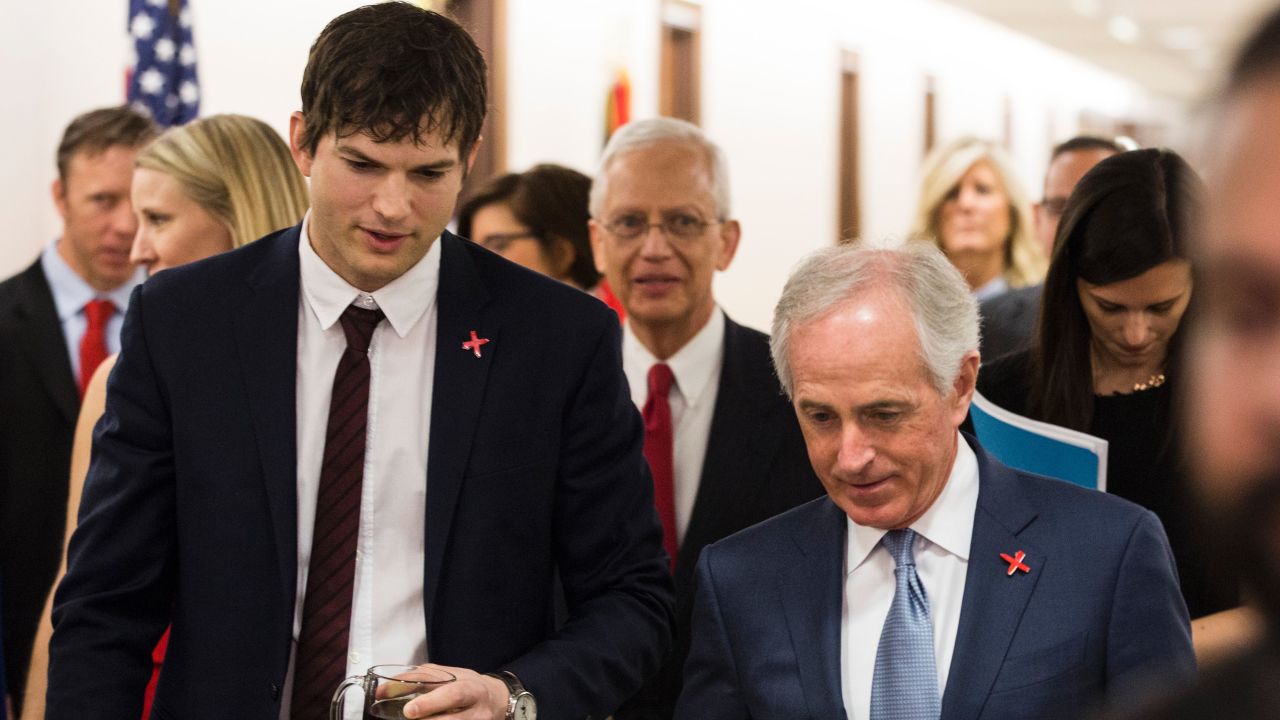 Ashton Kutcher walks with Senate Foreign Relations Committee Chairman Sen. Bob Corker (R-TN) before testifying on Capitol Hill on February 15, 2017 in Washington, DC.