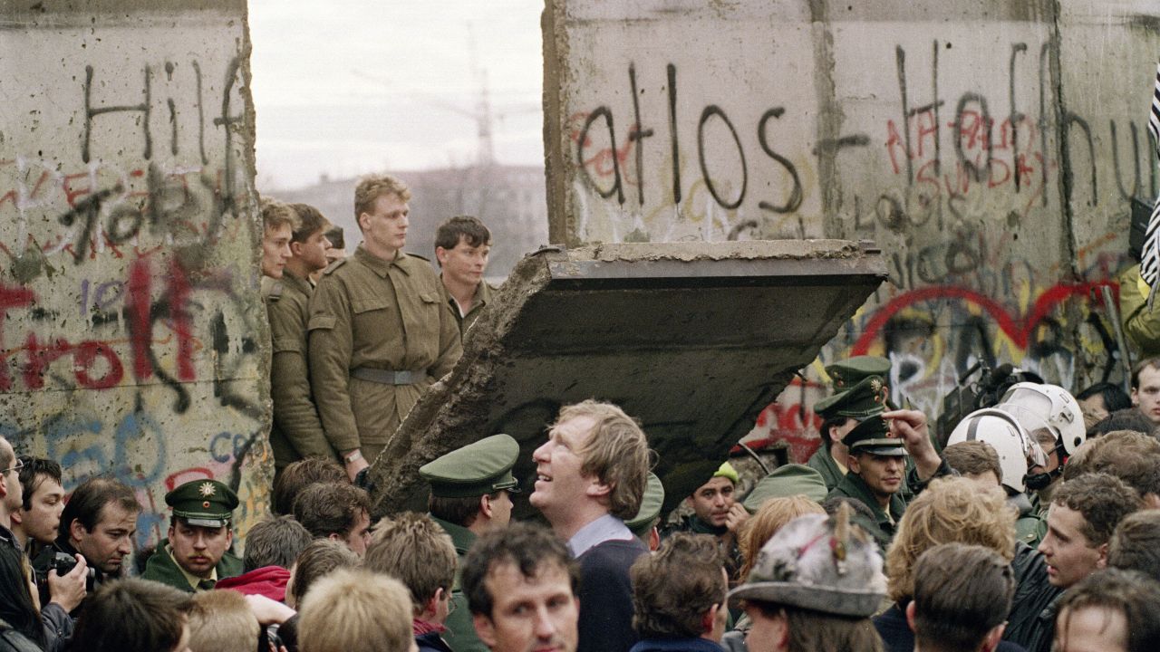 TO GO WITH AFP STORY by  Audrey KAUFFMANN and PACKAGE "Germany-east-History-20years"  FILES - West Berliners crowd in front of the Berlin Wall early 11 November 1989 as they watch East German border guards demolishing a section of the wall in order to open a new crossing point between East and West Berlin, near the Potsdamer Square. Two days before, Gunter Schabowski, the East Berlin Communist party boss, declared that starting from midnight, East Germans would be free to leave the country, without permission, at any point along the border, including the crossing-points through the Wall in Berlin. The Berlin concrete wall was built by the East German government in August 1961 to seal off East Berlin from the part of the city occupied by the three main Western powers to prevent mass illegal immigration to the West. According to the "August 13 Association" which specialises in the history of the Berlin Wall, at least 938 people - 255 in Berlin alone - died, shot by East German border guards, attempting to flee to West Berlin or West Germany.   AFP PHOTO / GERARD MALIE (Photo credit should read GERARD MALIE/AFP/Getty Images)