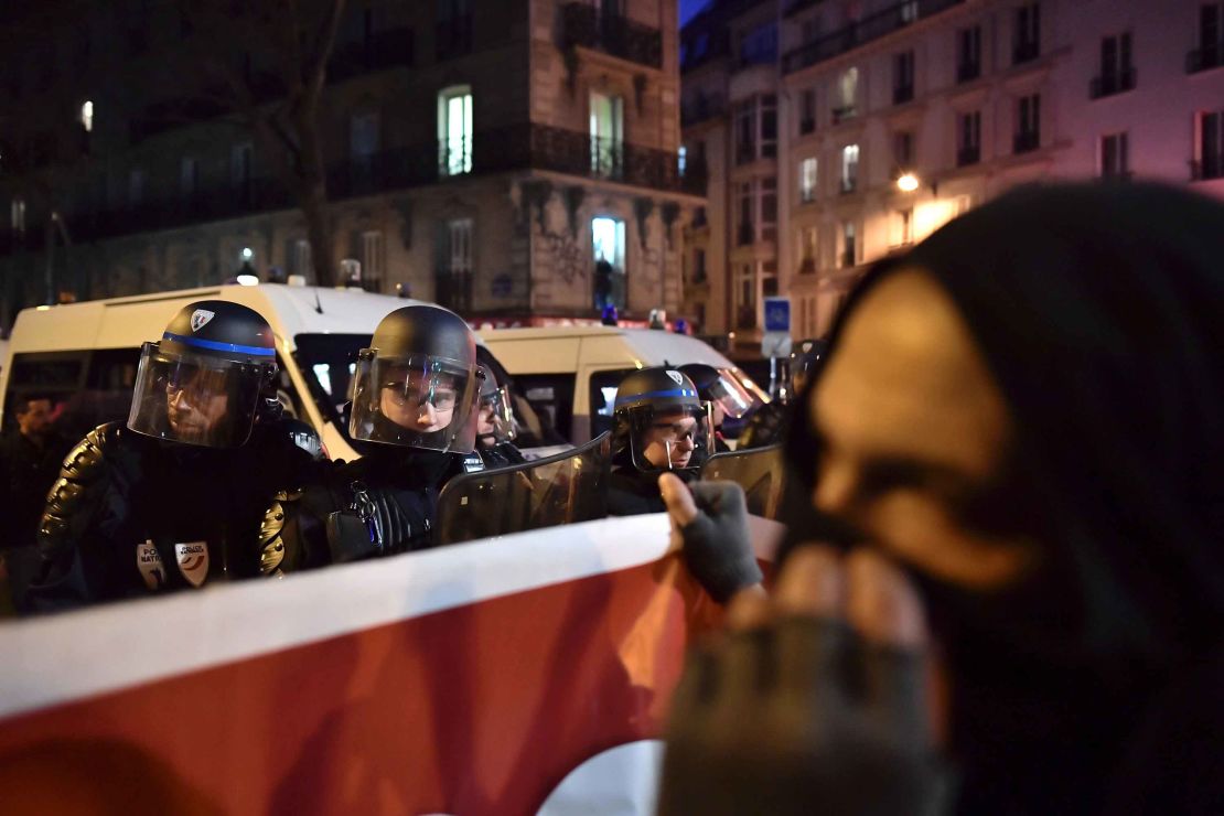 Riot police stand guard in Paris' Barbes neighborhood.