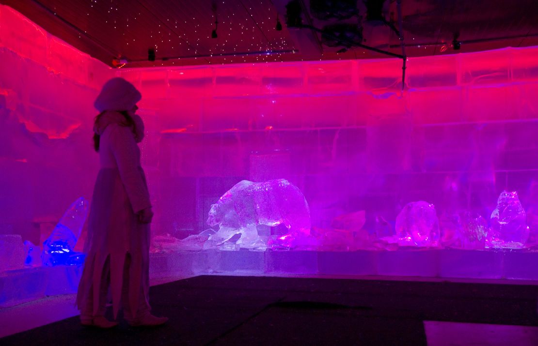 A girl walks among ice sculptures in the Santa Park near Rovaniemi, Finnish Lapland.