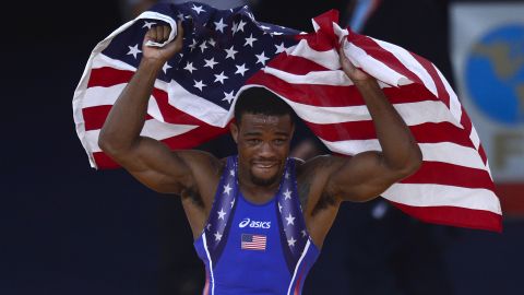 US' Jordan Ernest Burroughs celebrates with national flag after defeating Iran's Sadegh Saeed Goudarzi in their Men's 74kg Freestyle gold medal match on August 10, 2012 during the wrestling event of the London 2012 Olympic Games.
AFP PHOTO / YURI CORTEZ (Photo credit should read YURI CORTEZ/AFP/GettyImages)
