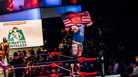 Lucha Libre wrestler Sam Adonis waves a Donald Trump flag as he is introduced to the crowd at Arena Mexico on Sunday, February 12.