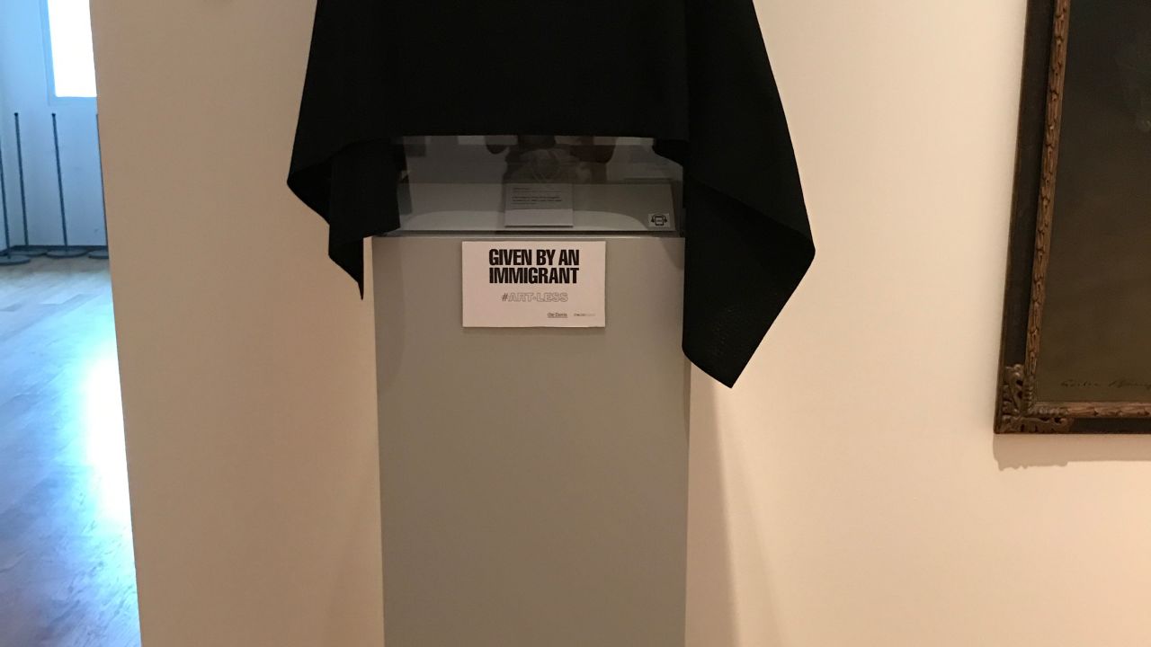Black cloth covers art that was given by an immigrant to the Davis Museum.