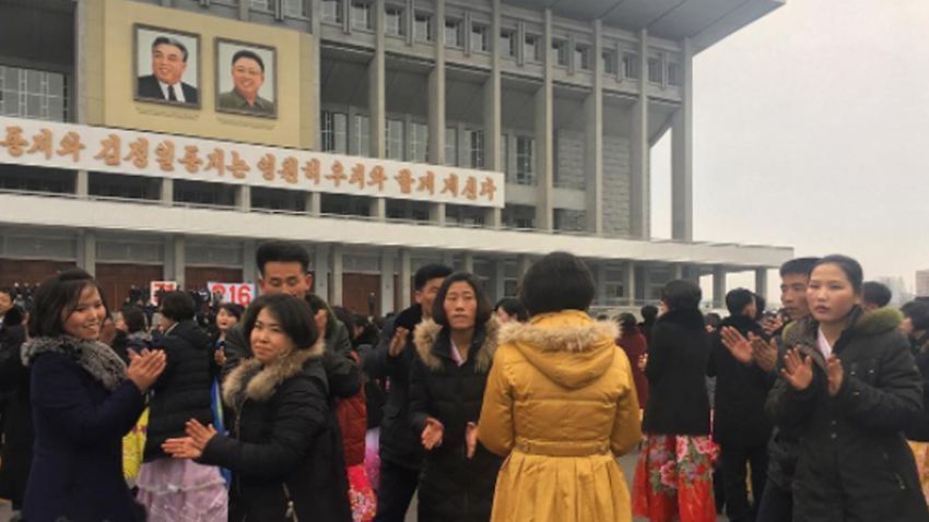 North Korea university students dance in front of the Pyongyang indoor stadium.