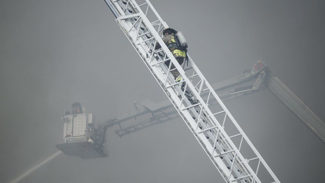 Firefighters battle a large blaze at a racquet club in Toronto on Tuesday, February 14. No civilians were injured, according to the Canadian Broadcasting Corporation.
