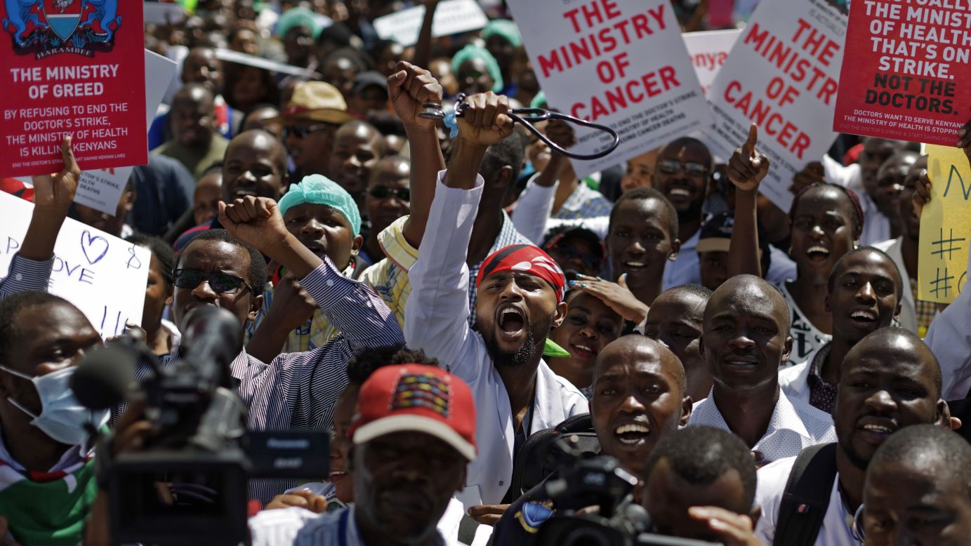 A doctor holds his stethoscope in the air as he and other medical staff protest the detention of their union leaders in Nairobi, Kenya, on Wednesday, February 15. Seven union leaders were jailed earlier this week for not calling off a strike by doctors working in public institutions. Their release was later ordered by an appeals court.
