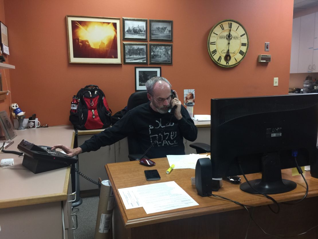 Eddy Carroll helps man the phones Thursday at the First Unitarian church in Denver.