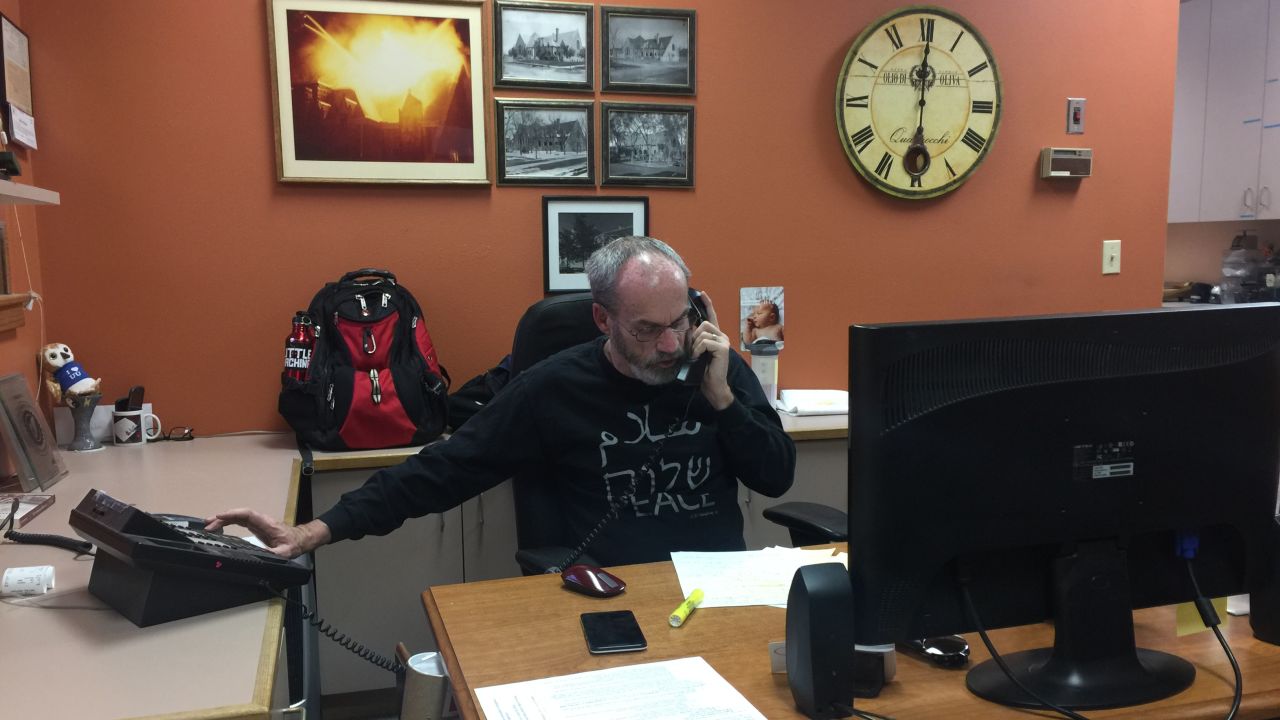 Eddy Carroll helps man the phones Thursday at the First Unitarian church in Denver.