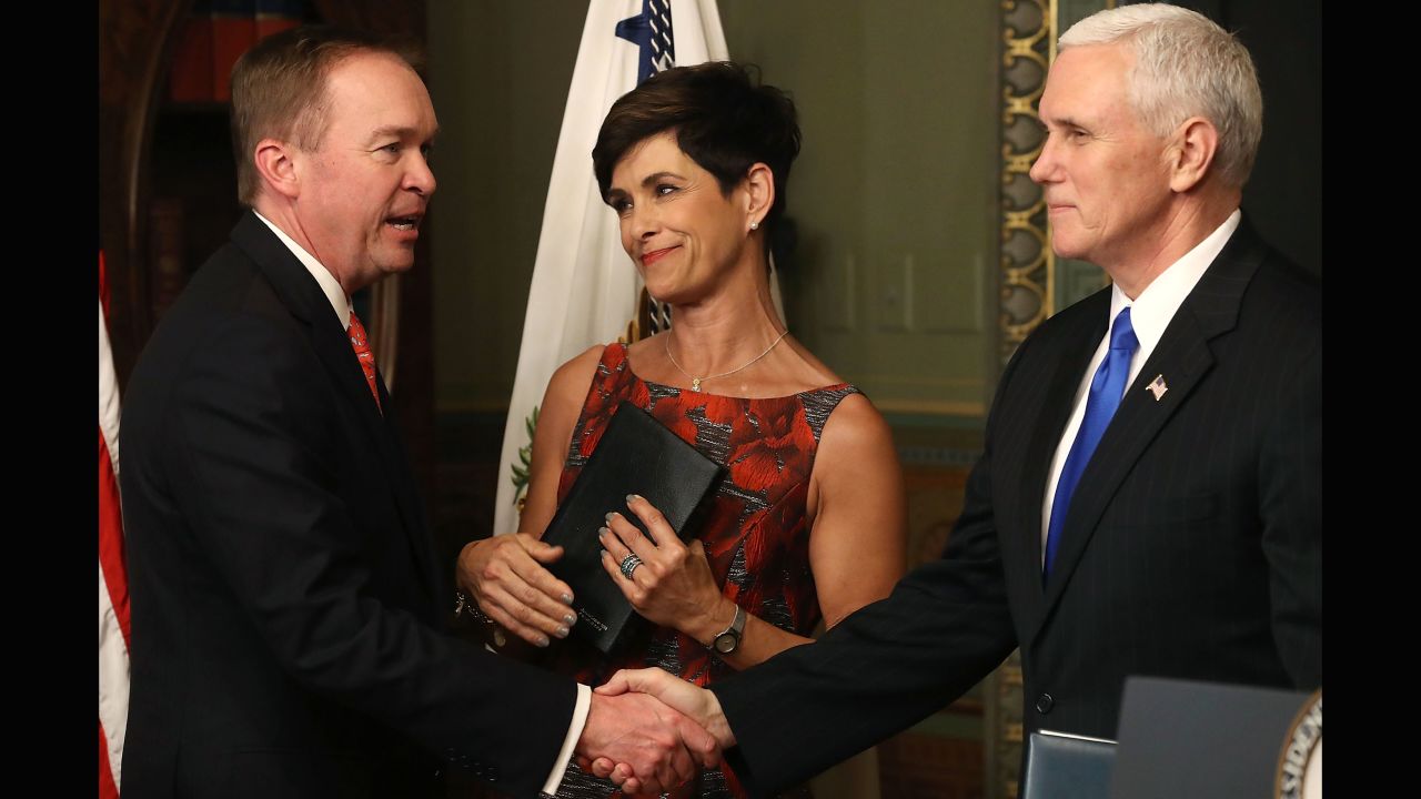 Pence shakes hands with Mick Mulvaney after swearing him in as the new director of the Office of Management and Budget on Thursday, February 16. Mulvaney's wife, Pam, looks on. Mulvaney had been a congressman since 2011.