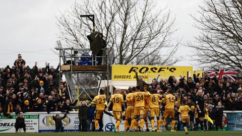 Sutton United players celebrate scoring the winning goal against Leeds United in the fourth round.