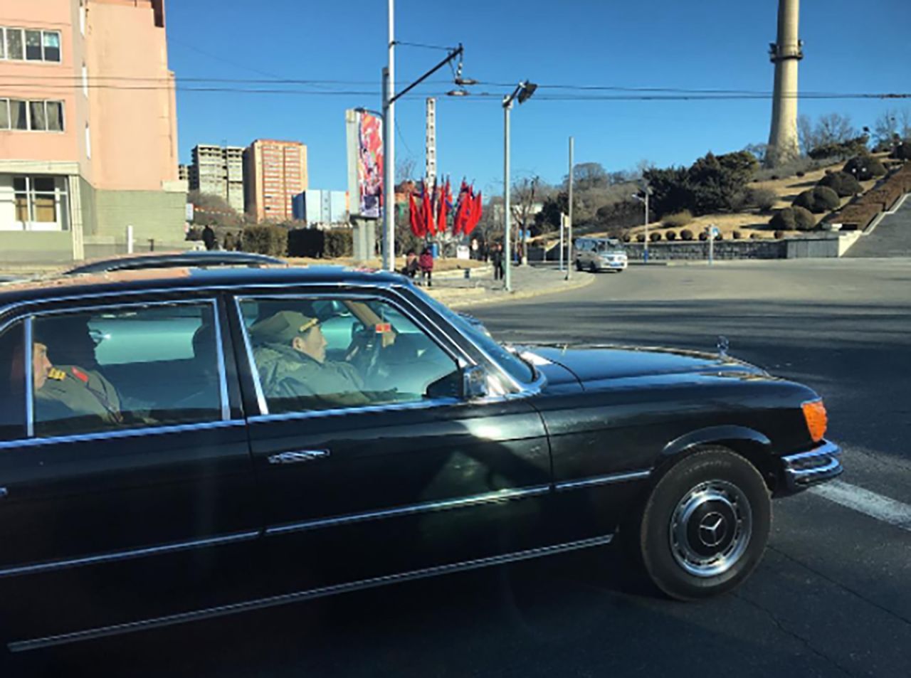 North Korean soldiers ride on February 17, in a black Mercedes-Benz on the streets of Pyongyang.