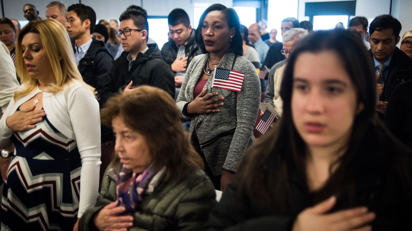 People listen to the national anthem during a naturalization ceremony in Newark, New Jersey, on Thursday, February 16.