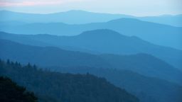 View from the Oconaluftee Overlook of the Oconaluftee Valley with hazy mountain ridges at sunrise in the Great Smoky Mountains National Park in North Carolina, USA.