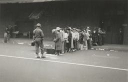 Japanese-Americans line up in Los Angeles for transport to the Santa Anita Race Track in April 1942.
