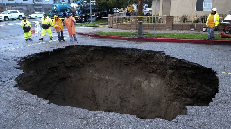 Inspectors check out a sinkhole that formed in Los Angeles' Studio City neighborhood on February 18 after the severe storm hit. 