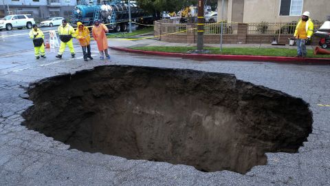 Inspectors check out a sinkhole that formed in Los Angeles' Studio City neighborhood on February 18 after the severe storm hit. 