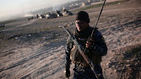 A member of the Iraqi federal police operates a radio in the town of Hamam al-Alil on Sunday as Iraqi forces begin the offensive against ISIS in western Mosul.