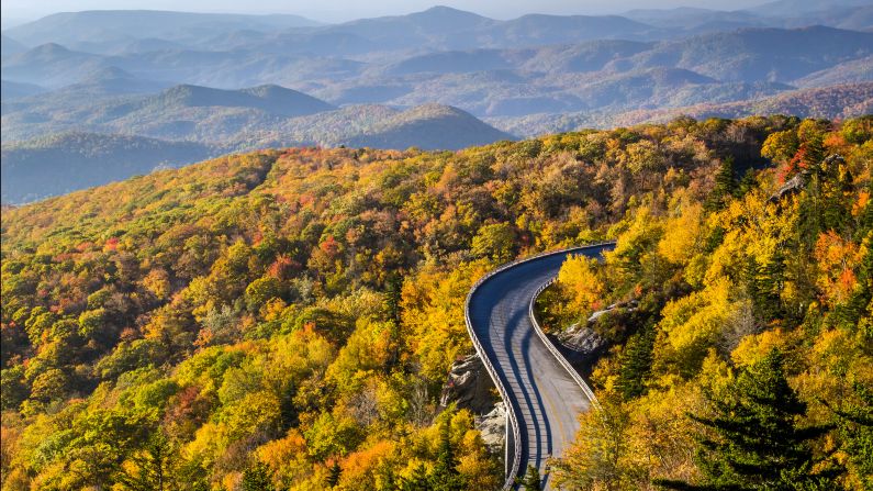 <strong>2. Blue Ridge Parkway, North Carolina/Virginia:</strong> Blue Ridge Parkway meanders for 469 miles through two states, revealing gorgeous views of the Appalachian Highlands that vary incredibly by season. Autumn's changing foliage is evident in a sunrise view of the Linn Cove Viaduct at Milepost 304 in North Carolina. 