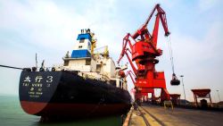 This photo taken on March 29, 2016 shows imported coal being unloaded from a cargo ship at a port in Lianyungang, east China's Jiangsu province. 
Huge industrial overcapacity will drag on China's growth this year, the Asian Development Bank (ADB) said on March 30 as it cut its forecast for the world's second-largest economy. / AFP / STR / China OUT        (Photo credit should read STR/AFP/Getty Images)