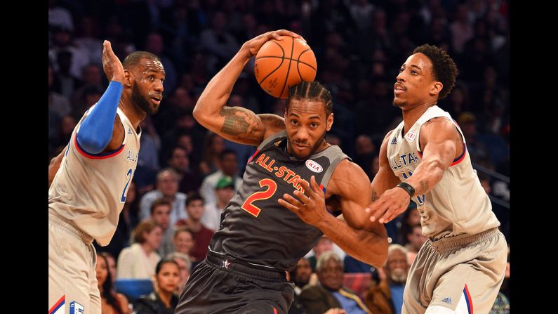 The game included somewhat less intense defense on both teams than in previous years. Nonetheless, this drive to the basket by Western forward Kawhi Leonard was met by Eastern guard DeMar DeRozan, right, and  Eastern forward LeBron James. 