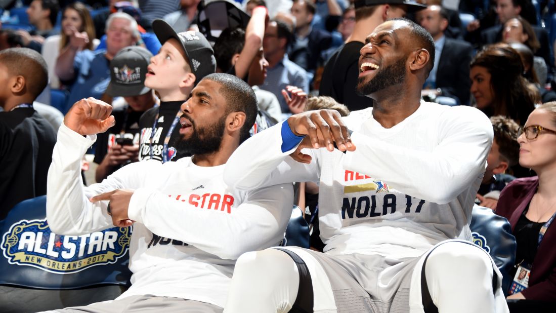Kyrie Irving, left, and James enjoy a moment while watching from the bench. 