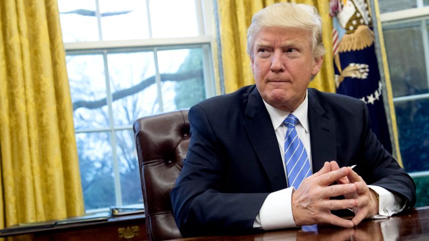 US President Donald Trump prepares to sign several executive orders in the Oval Office of the White House in Washington, DC, January 23, 2017.
Trump on Monday signed three orders on withdrawing the US from the Trans-Pacific Partnership trade deal, freezing the hiring of federal workers and hitting foreign NGOs that help with abortion. / AFP / SAUL LOEB        (Photo credit should read SAUL LOEB/AFP/Getty Images)