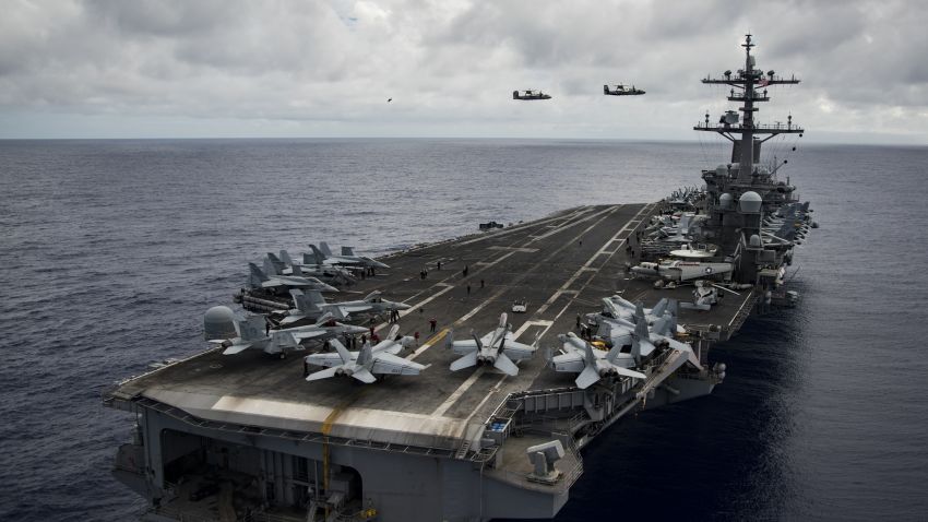 170209-N-GD109-083
PACIFIC OCEAN (Feb. 9, 2017) Two E-2C Hawkeye early warning and control aircraft assigned to the "Black Eagles" of Carrier Airborne Early Warning Squadron (VAW) 113 fly over the aircraft carrier USS Carl Vinson (CVN 70) during a change of command ceremony. The ship's carrier strike group is on a western Pacific deployment as part of the U.S. Pacific Fleet-led initiative to extend the command and control functions of U.S. 3rd Fleet. (U.S. Navy photo by Mass Communication Specialist 2nd Class Zackary Alan Landers/Released)