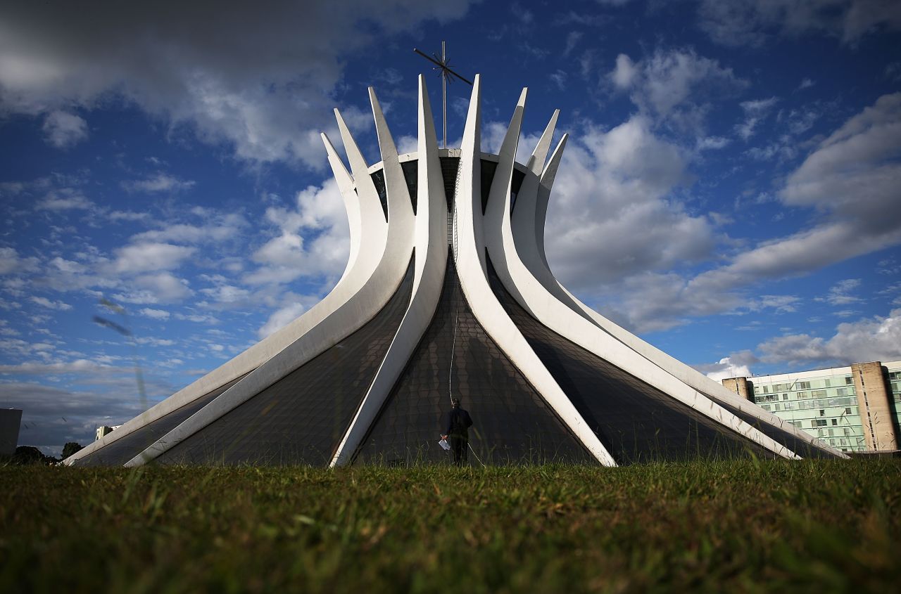 <strong>Icons</strong>: (National Congress) 1 point<br /><strong>Height</strong>: 0 points<br /><strong>Beauty</strong>: 2 points<br /><strong>Total: </strong>3 points<br />Oscar Niemeyer certainly made his mark on this city. The Ministries Esplanade contains his beautiful Cathedral of Brasilia (pictured here) National Museum and National Library. The building that defines the skyline, however, is his National Congress building that looks like two flying saucers parked next to two gray slabs.