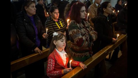 A young girl takes part in a Christmas Day Mass at a church in the predominantly Christian town of Qaraqosh. The area's churches were heavily damaged by ISIS militants before the town was freed by Iraqi forces during the Mosul offensive.