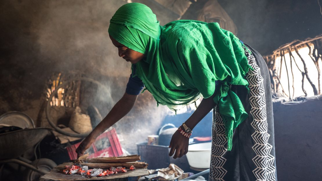 Batulo makes bread in a small kitchen at the Kakuma camp. Now that her parents and siblings have left, she's staying with another family to make sure she has enough food.