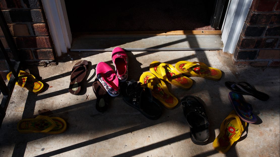Abdalla and his family leave their shoes outside their apartment in Clarkston, Georgia. Today, they've left the door ajar to let in the breeze. But on some days when a stranger knocks, they're still scared to open it.