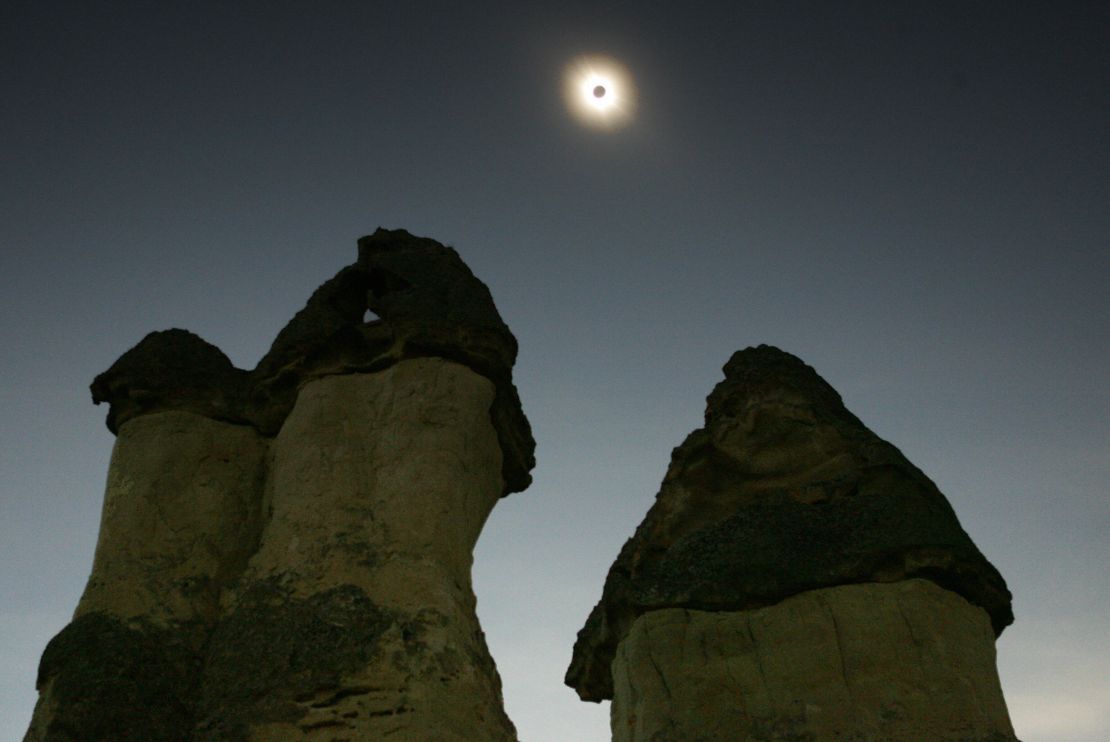 An eclipse of the sun is seen through the Fairy Chimneys in Turkey.