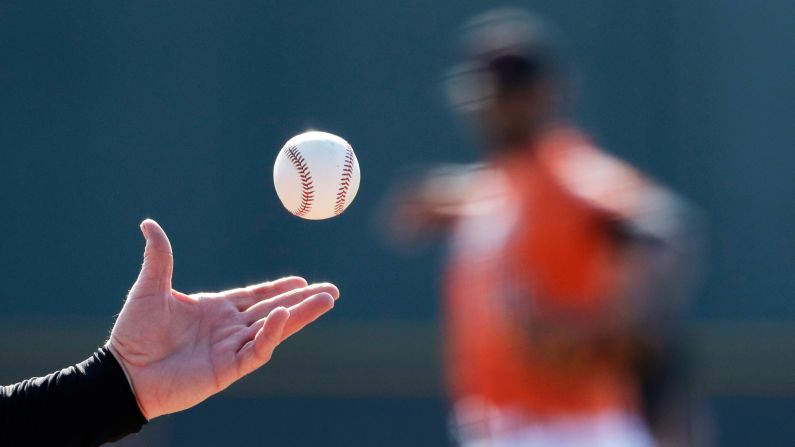 Baltimore Orioles coach Ron Johnson hits grounders to pitchers during a spring-training workout in Sarasota, Florida, on Wednesday, February 15.