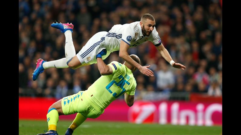 Real Madrid striker Karim Benzema jumps over Napoli goalkeeper Pepe Reina during a Champions League match in Madrid on Wednesday, February 15. Madrid, the tournament's defending champions, won 3-1 in what was the first of a two-legged tie.