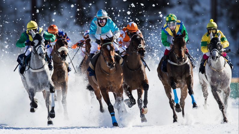 Horses race in the snow in St. Moritz, Switzerland, on Sunday, February 19.