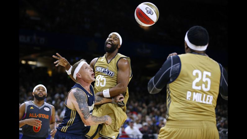 Former NBA star Baron Davis, center, passes to Percy Miller -- aka rapper Master P -- during the NBA All-Star Celebrity Game on Friday, February 17.