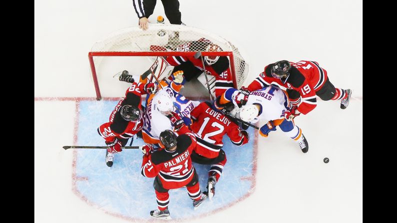 New Jersey goalie Cory Schneider is knocked into his own net during an NHL game against the New York Islanders on Saturday, February 18.