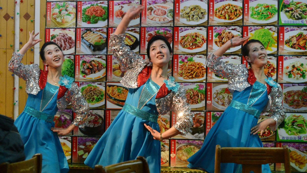Ethnic Koreans dance at a restaurant in Dandong.