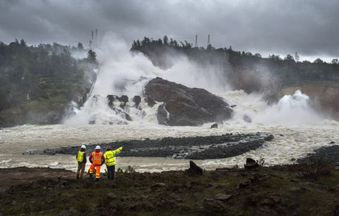 A member of Cal Fire, right, talks to workers on the Oroville Dam project in front of the main spillway in Oroville on February 20. Officials are keeping an eye on the dam <a href="http://www.cnn.com/2017/02/16/opinions/dam-in-california-lall-ho-opinion/index.html" target="_blank">after mandatory evacuations last week</a> amid concerns an emergency spillway could fail and threaten communities.