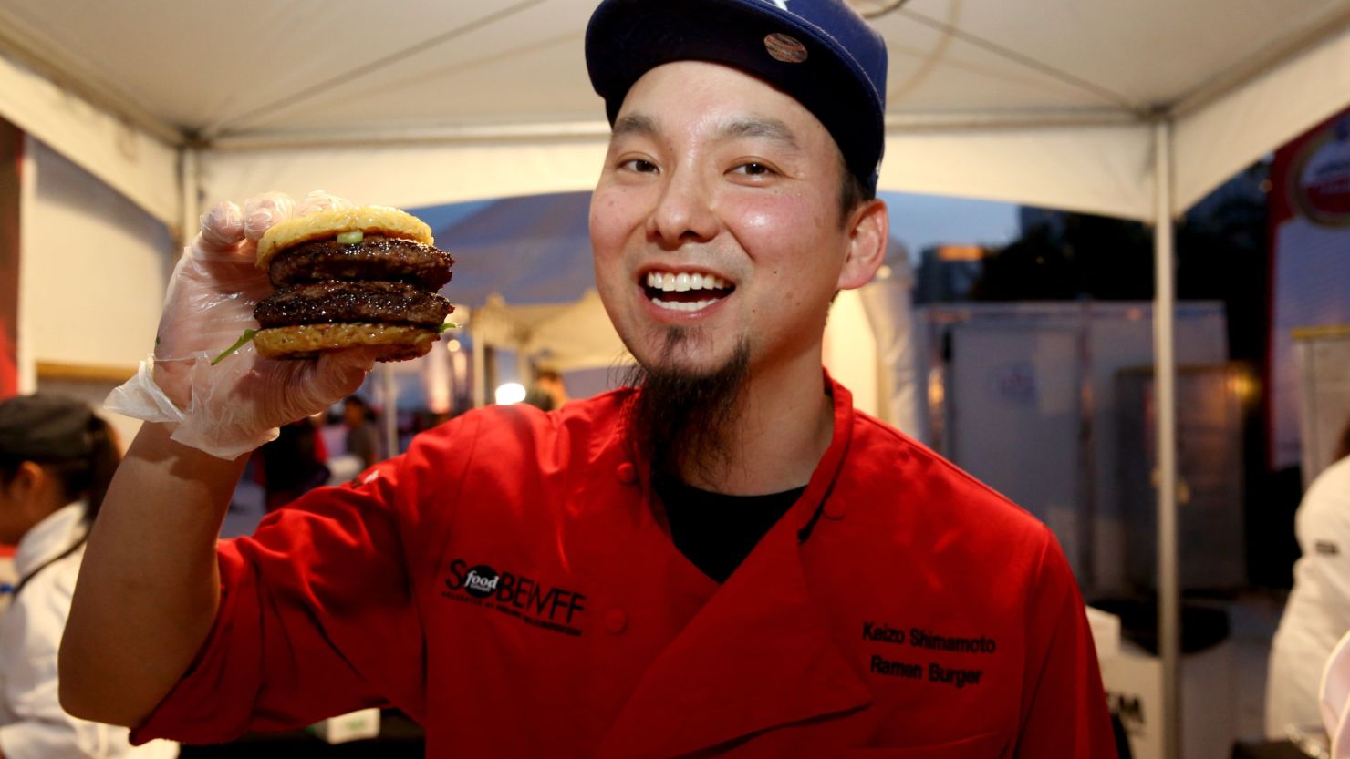 Chef Keizo Shimamoto of Ramen Burger poses with his creation.