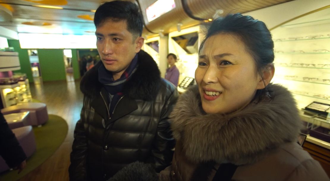 North Korean housewife Kim Chun Ae, standing with her husband Kim Chol Ryong, says she is not the "slightest" bit interested in who is US president.
