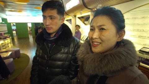 North Korean housewife Kim Chun Ae, standing with her husband Kim Chol Ryong, says she is not the "slightest" bit interested in who is US president.