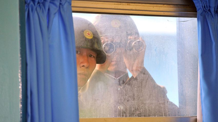 PANMUNJOM, SOUTH KOREA - JULY 15:  North Korean soldiers look in from outside the UN Command Military Armistice Commission meeting room as newly appointed commander General James Thurman (not in picture), commander of the United Nations Comand (UNC), Combined Forces Command (CFC), and United States Forces Korea (USFK) visit to the border village of Panmunjom on July 15, 2011 in Panmunjom, South Korea. Thurman was appointed on Thursday as the commander of 28,500 American troops in South Korea in his capacity as commander of United States Forces Korea.  (Photo by Jung Yeon-Je-pool/Getty Images)
