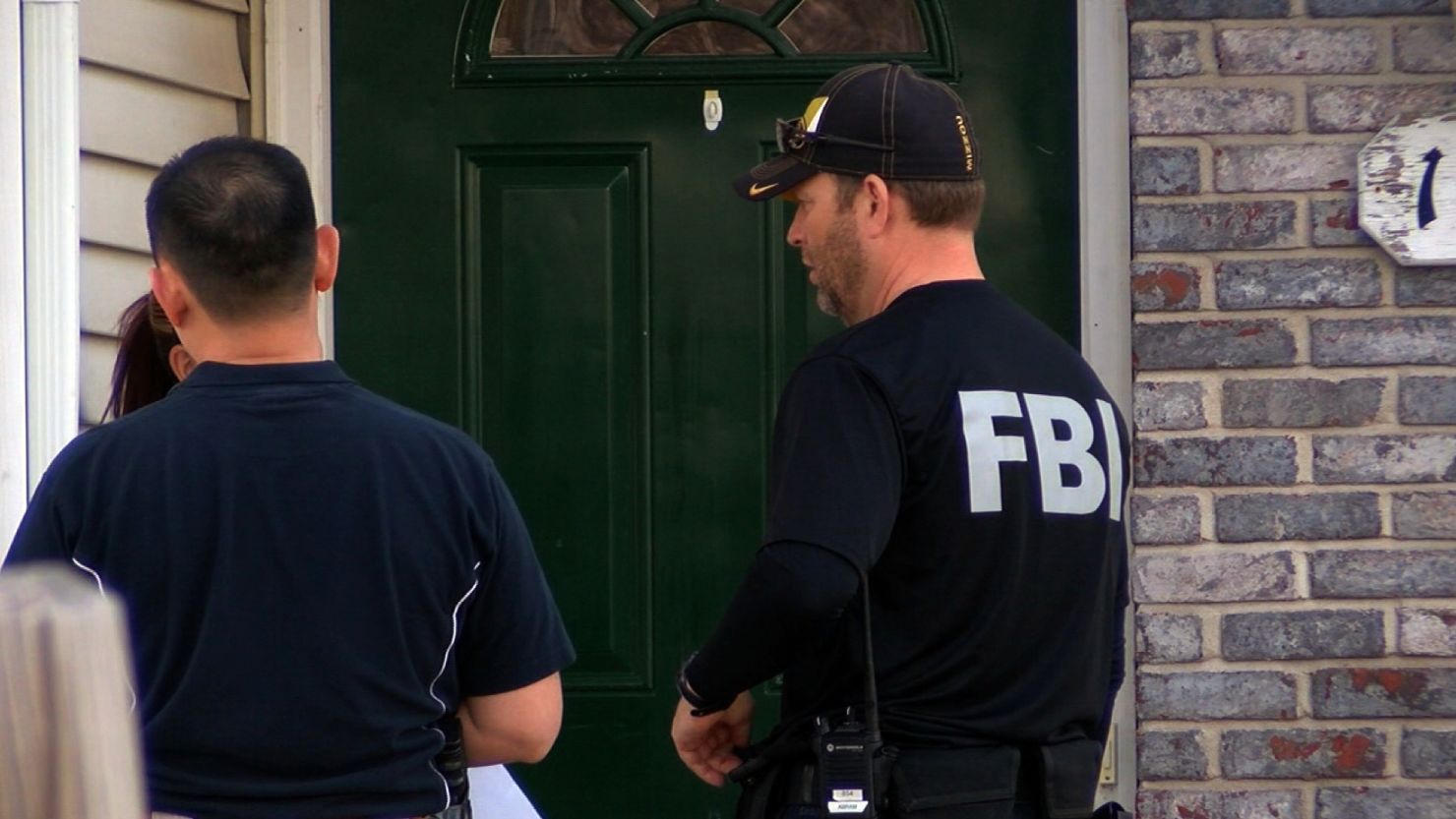 FBI agents stand in front of the home of Robert Lorenzo Hester Jr. of Columbia, Missouri.