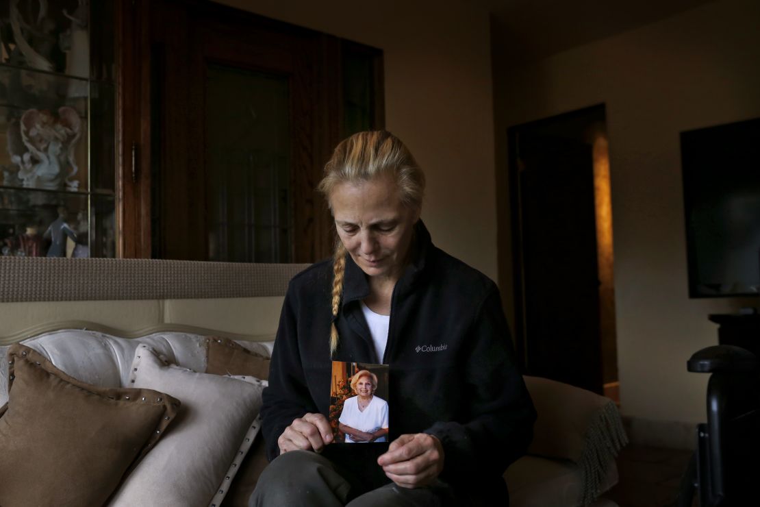 Bobbi Young holds a photo of her mother, Marilyn Young, the day after she passed away at home in Carmel Valley, California.